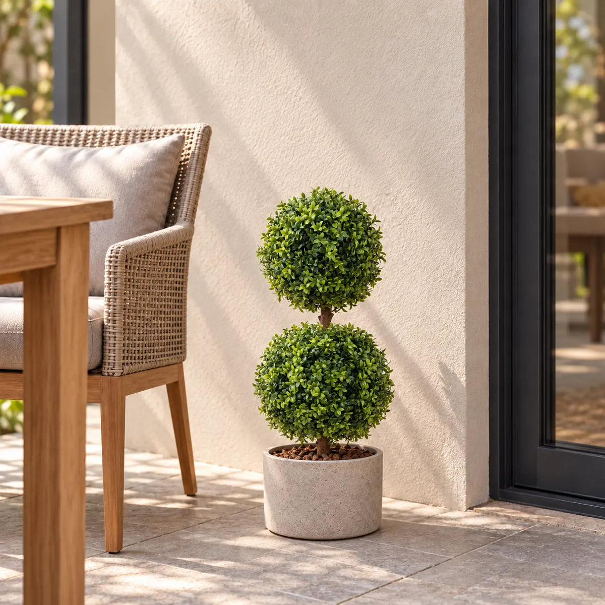 Artificial two ball boxwood topiary in a stone-look outdoor planter