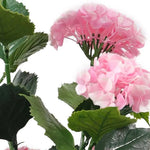 Detail view of pink artificial hydrangea blooms and textured foliage