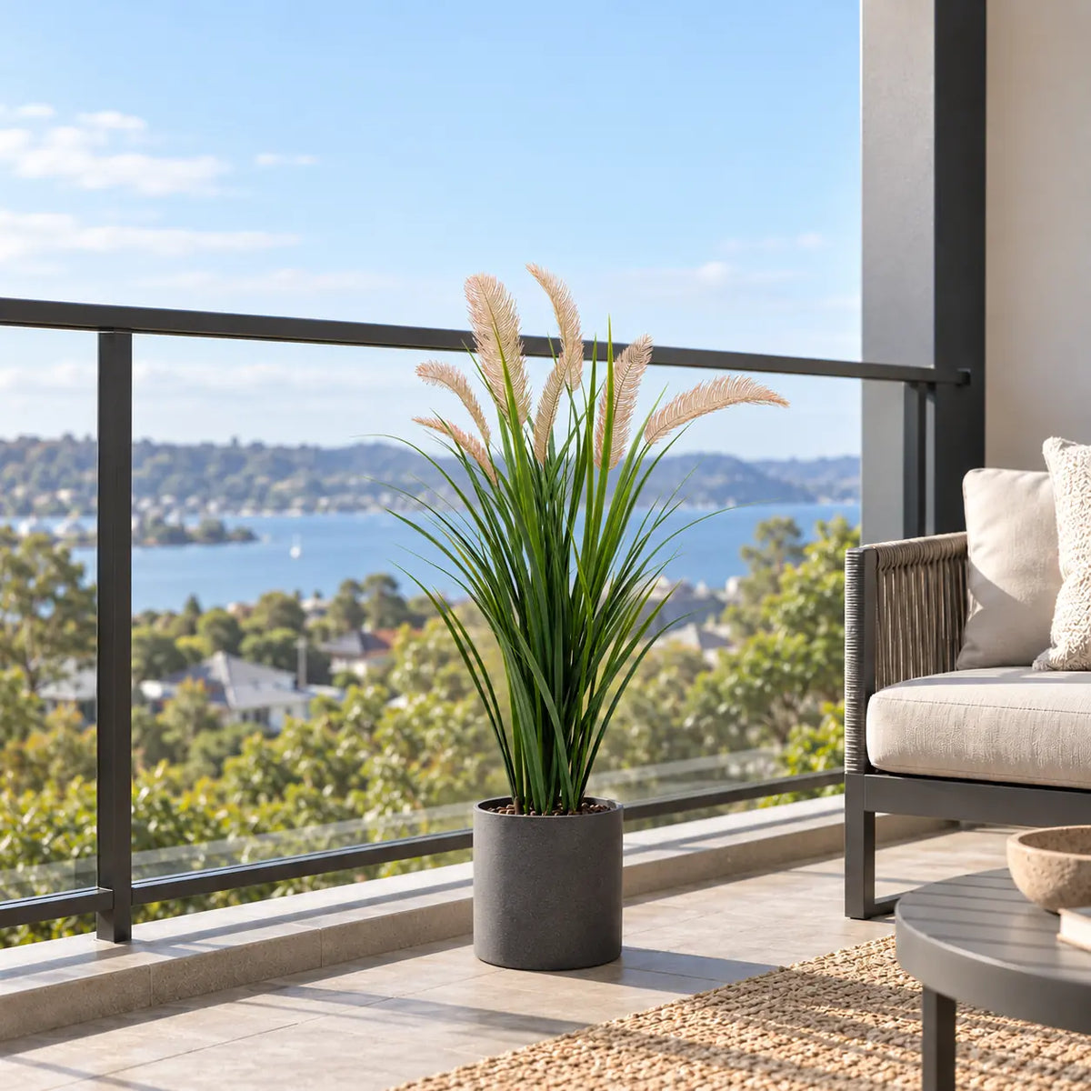 Artificial flowering reed grass in a decorative balcony planter