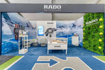 Group 1 Fire Certified Luxury White Lily artificial green wall installed as a premium exhibition feature wall, creating a realistic greenery backdrop for a branded display.