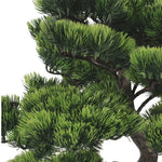 Close-up of a artificial green tree with a white background