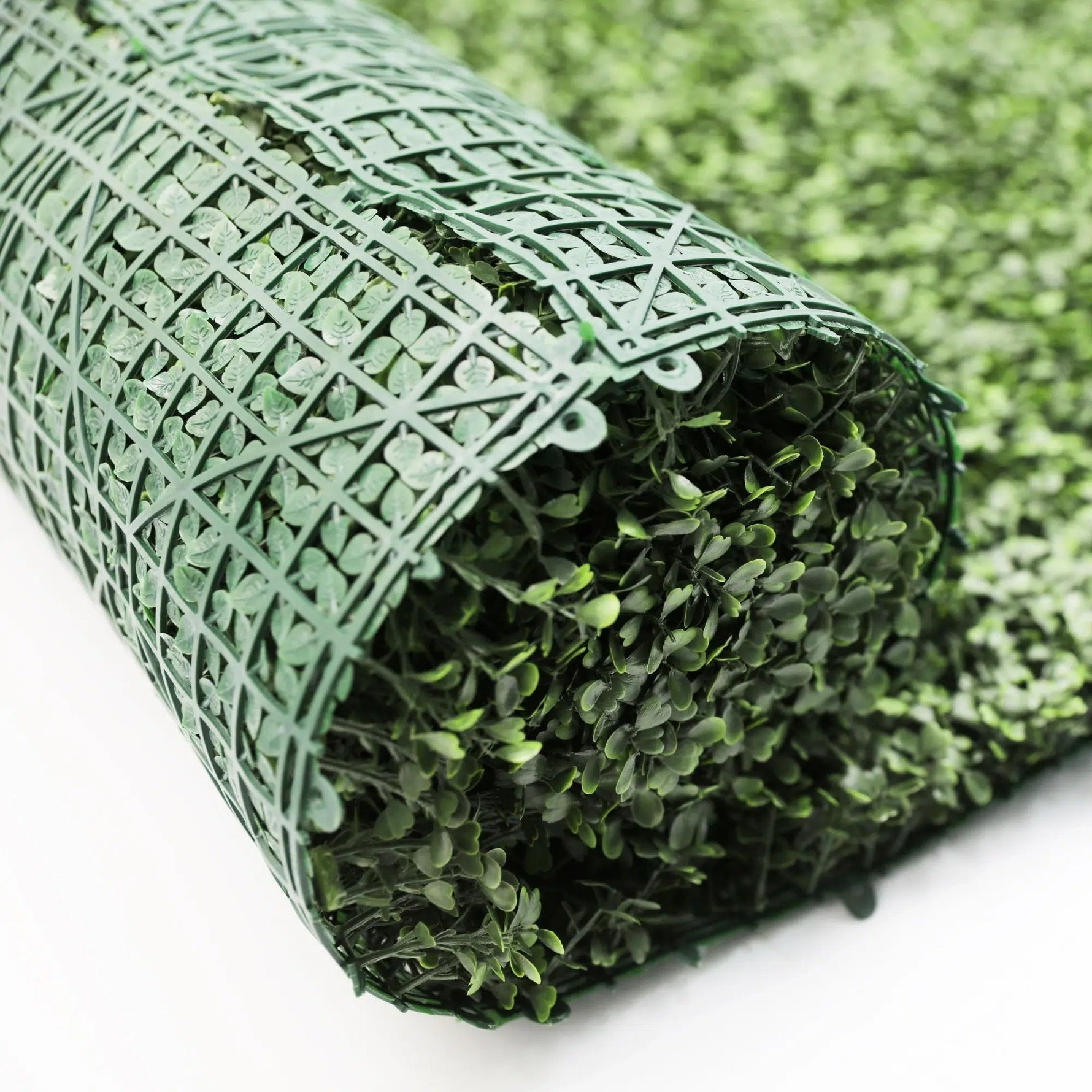 Roll of artificial grass on a white background