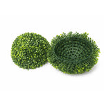 Two artificial green boxwood balls on a white background