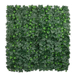 Square panel of artificial green ivy leaves on a white background
