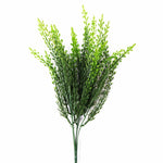 Artificial green plant branch on a white background