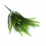 Green artificial plant branch on a white background