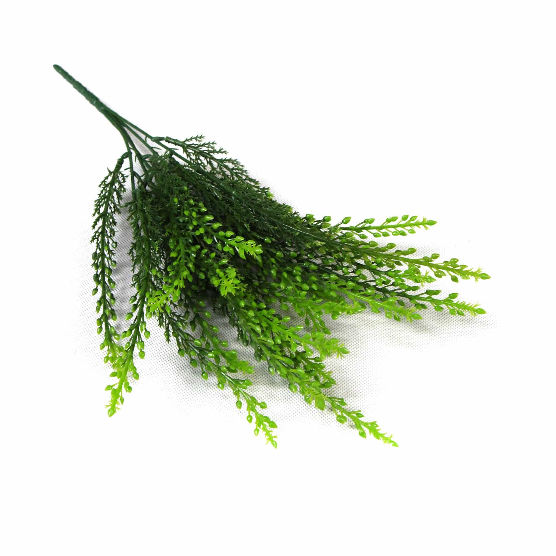 Green artificial plant branch on a white background