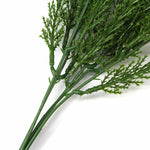 Artificial green plant branch on a white background
