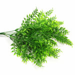 Artificial green leaves on a white background