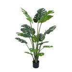 Artificial potted plant with large green leaves on a white background