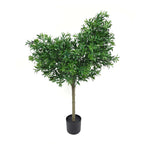 Potted artificial tree with green leaves on a white background