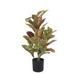Artificial potted plant with green and brown leaves on a white background