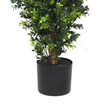 Potted artificial plant with green leaves on a white background