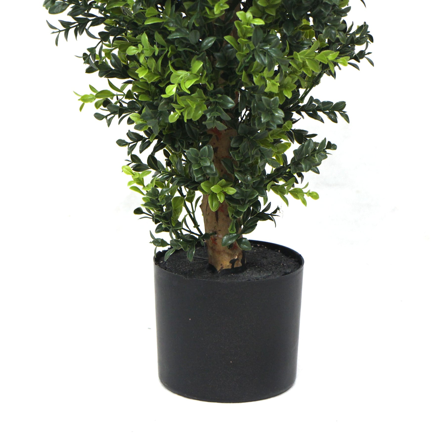 Potted artificial plant with green leaves on a white background