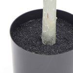 Close-up of a candle being extinguished with a black container below.
