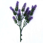 Artificial lavender branch with purple flowers on a white background