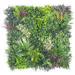 Artificial green wall panel with various green plants on a white background