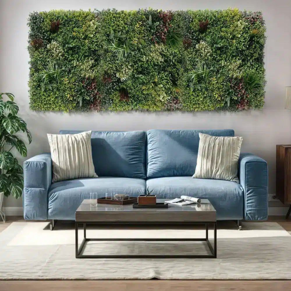 Blue sofa with decorative pillows in a living room setting with a green wall art piece.