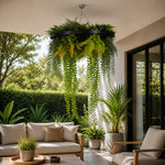 Outdoor patio with a hanging plant chandelier, sofa, and chairs.