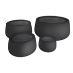 Set of four black stone-like stools on a white background