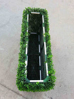 Rectangular planter with greenery on a concrete surface