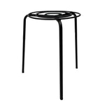 Black metal side table with spiral design on a white background