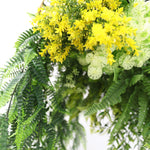Close-up of a bouquet with yellow flowers and green leaves on a white background