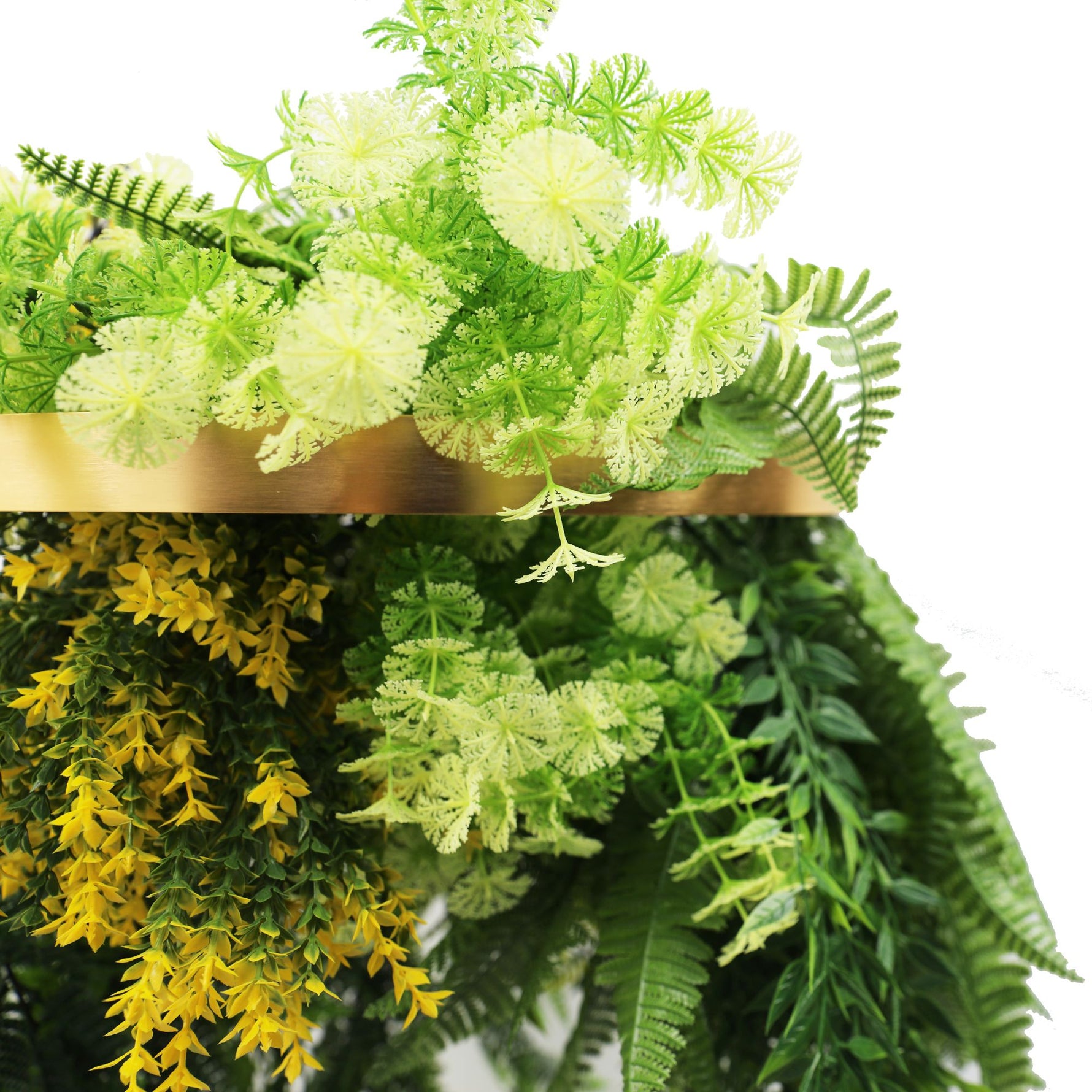 Artificial greenery with a gold frame on a white background