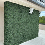 Artificial green wall panel on a building exterior
