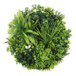 Artificial greenery ball with various types of leaves on a white background