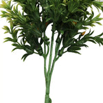 Artificial green plant branch on a white background
