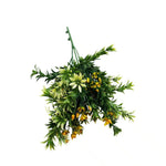 Artificial hanging plant with green leaves and small yellow flowers on a white background