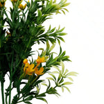 Artificial green plant with yellow flowers on a white background