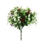 Artificial greenery with white flowers and red accents on a white background