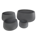 Set of four gray planters of different sizes on a white background