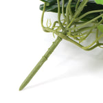 Close-up of green artificial plant stems on a white background