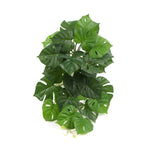 Artificial monstera plant leaves on a white background