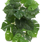 Artificial monstera plant leaves on a white background