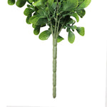 Artificial green leaf branch on a white background