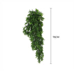 Artificial green garland with measurement label on a white background