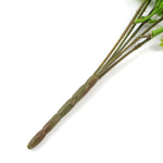 Artificial green stems with leaves on a white background