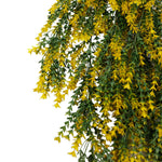 Artificial hanging plant with yellow flowers and green leaves on a white background