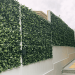 Artificial greenery panels on a building facade