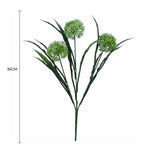 Artificial green plant with three branches on a white background