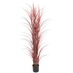 Artificial potted plant with red leaves on a white background