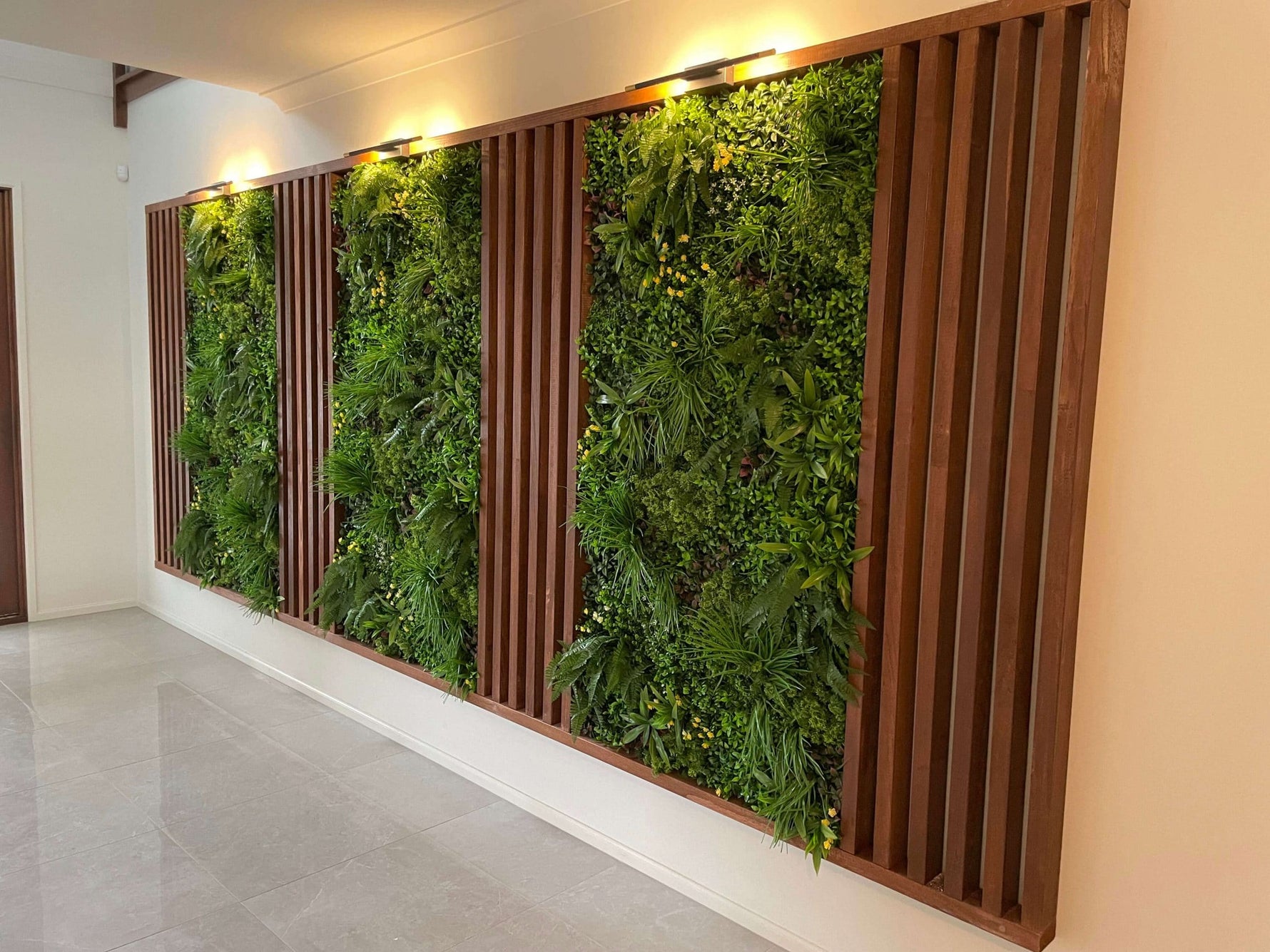 Living green wall with wooden slats in a modern indoor setting