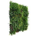 Artificial vertical garden panel with various green plants on a white background