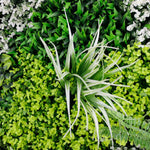 Artificial greenery with a focus on a single plant in the foreground