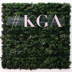 Living green wall with '#KGA' text overlay