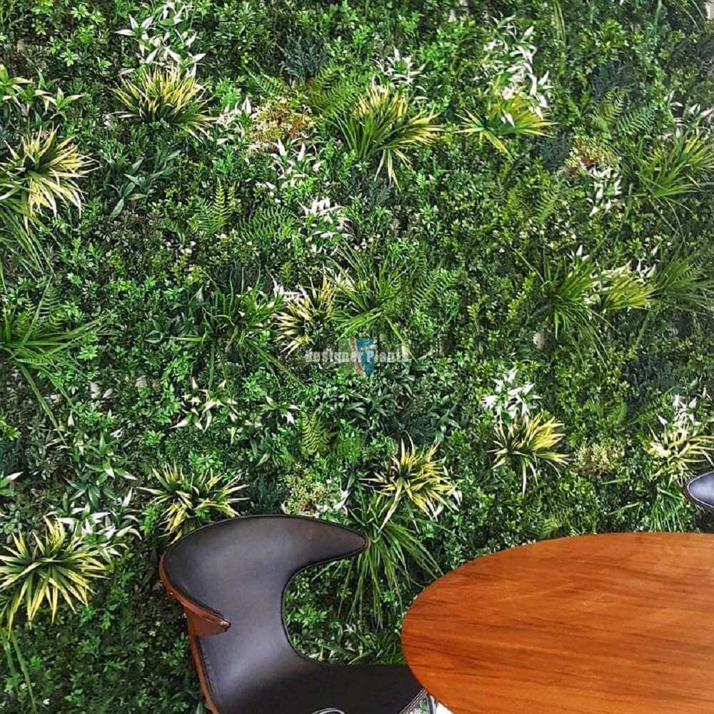 Artificial green wall with a chair and table in front